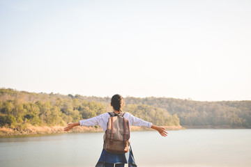 Happy Asian girl backpack  in nature background, Relax time on holiday concept travel ,color of vintage tone and soft focus