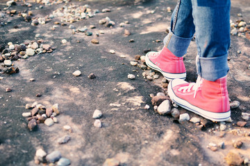 Feet red sneaker a girl in nature and relax time on holiday. selective and soft focus color of vintage tone
