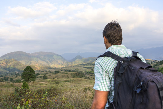 Hiker overlooking hilly landscape in Chiapas, Mexico
