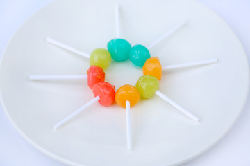 lollipop candies in white plate on white background