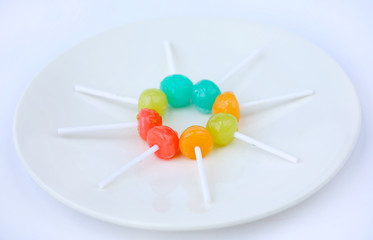 lollipop candies in white plate on white background