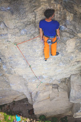 Rock climber resting on a rock.