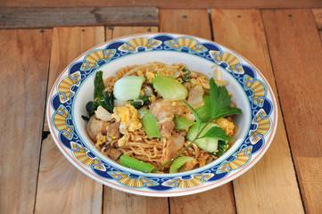 Instant noodles fried with egg Pork and vegetables. copy space.