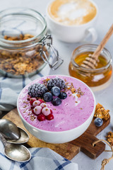 Breakfast - yogurt bowl with granola and berries, coffee, honey