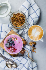 Breakfast - yogurt bowl with granola and berries, coffee, honey