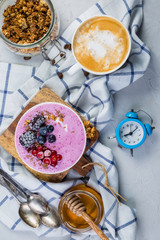 Breakfast - yogurt bowl with granola and berries, coffee, honey