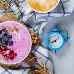 Breakfast - yogurt bowl with granola and berries, coffee, honey