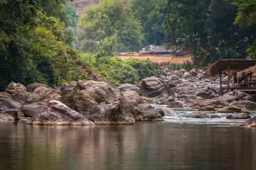 Beautiful River water flowing through stones and rocks at dawn
