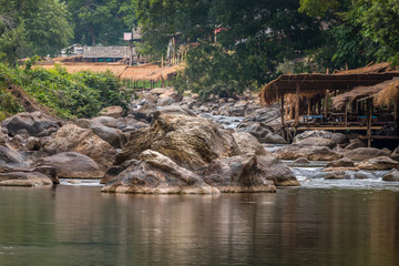 Beautiful River water flowing through stones and rocks at dawn