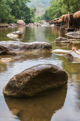 Beautiful River water flowing through stones and rocks at dawn