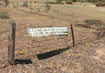 Keep Out sign painted on corrugated iron in Australia