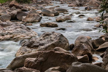 Beautiful River water flowing through stones and rocks at dawn