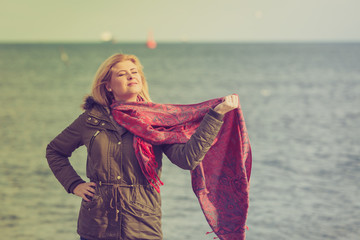Woman with red scarf on beach