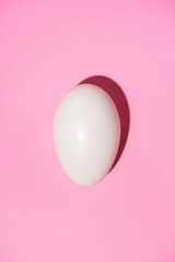 Top view of eggs on pink background