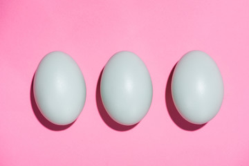 Top view of eggs on pink background