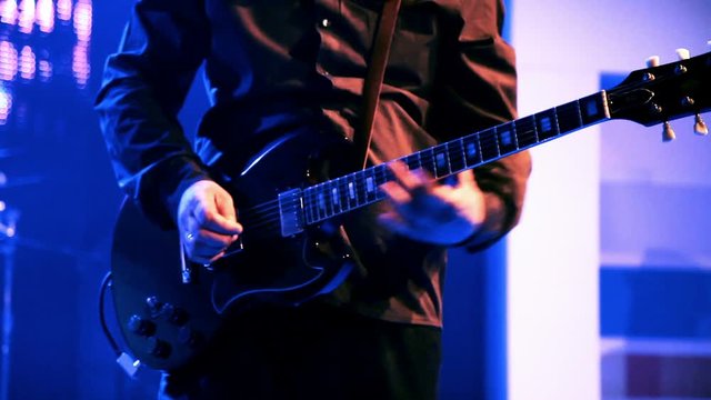 playing electric guitar on stage