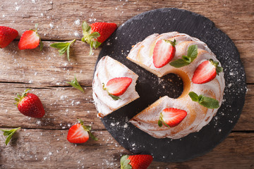 Fototapeta na wymiar Pound Cake cake with mint and strawberry close-up. horizontal top view