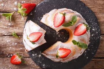 Sliced pound cake with fresh mint and strawberries close-up. horizontal top view