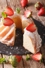 Vanilla biscuit cake with mint and strawberry close-up. vertical