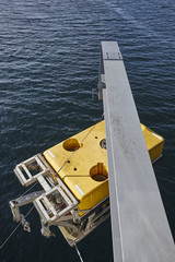 Scientific submarine robot with crane ready to be submerged.