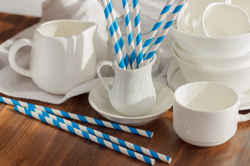 Set of white empty tableware with striped tubules