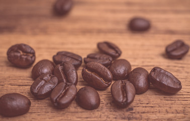 Roasted coffee beans on wood texture background