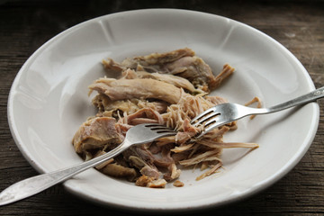 Boiled meat in a plate and two forks