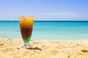 Fresh and colorful coctail on the background of the Caribbean Sea.