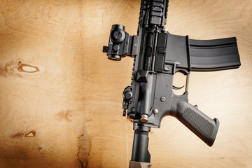 black assault rifle on an old wooden table