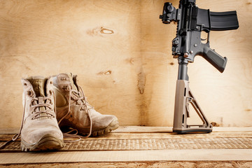 black assault rifle on an old wooden table