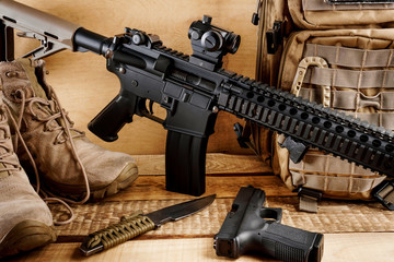 black assault rifle on an old wooden table