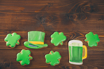 Fototapeta na wymiar Beautiful background for St. Patrick's day with ginger clover, hat and a glass of green beer on a wooden table. Free space