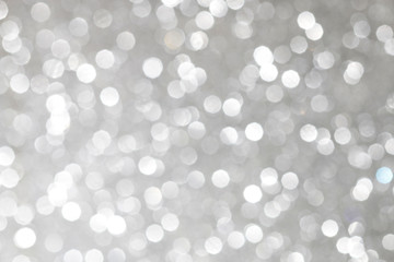 Fototapeta na wymiar Silver glittering christmas lights. Blurred abstract background