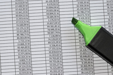 Marker over excel spreadsheet showing accounting data.