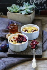 Crumble plum pie. Words and prices handwritten on blackboard