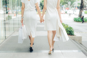 Fototapeta na wymiar Beautiful asian girls with shopping bags walking on street at the mall