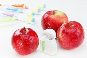 Dental teeth floss, toothbrush and red apple