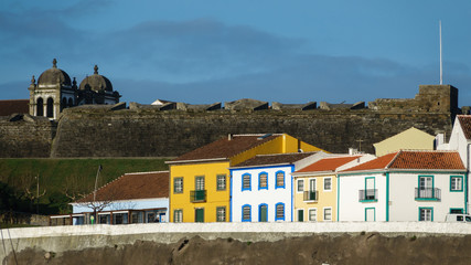 Colorful, bright view of houses and fort in Angra do Heroismo