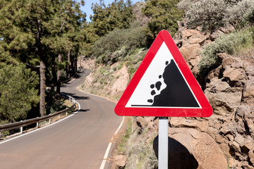 Road sign falling stones, Traffic sign caution possible falling rocks from the mountains