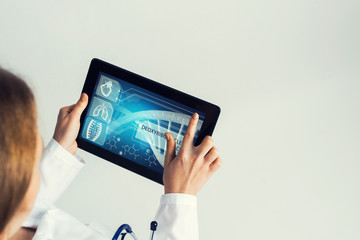 Close of female doctor hands working with tablet pc computer