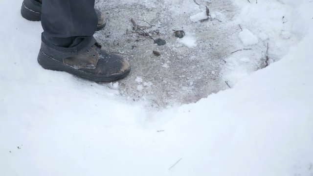 Men's old shoes in the snow