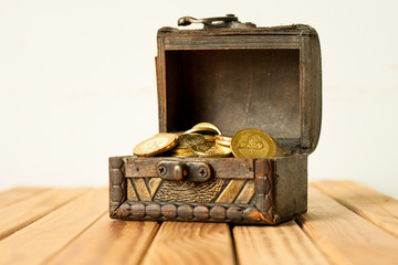 A box of coin over the wooden table