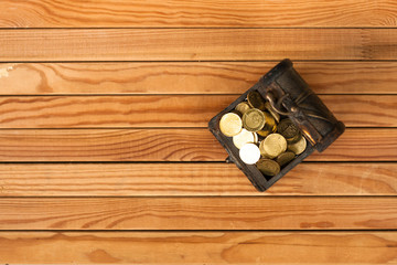 A box of coin over the wooden table