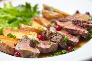 Tasty roasted pork meat with potatoes