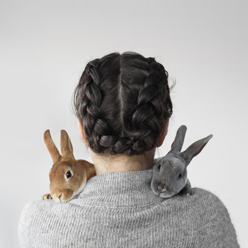Cute pet bunny rabbits cuddling woman