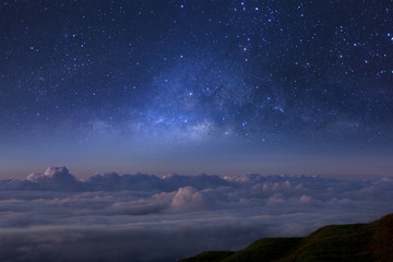Milky way galaxy over foggy mountains in Thailand. Long exposure photograph.with grain