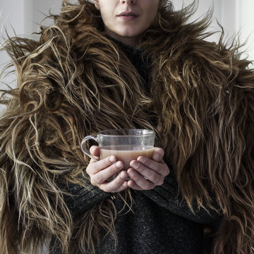 Woman holding hot drink 