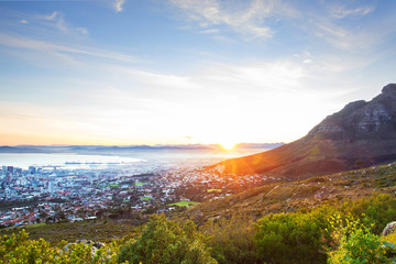 View of a beautiful sunrise behind Cape Town mountains and city