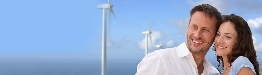 Obraz premium Couple standing in front of wine turbines