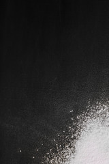 Flour on a black background. Abstract design of white dust cloud